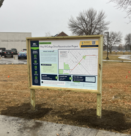 A sign posted outside the local library provides a summary of the work