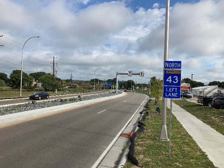 Hwy 43 through Winona after  construction, showing a median (left), and a new sidewalk (right)