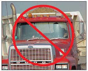 Belly dump truck with a non-approved lighting package. The rotating beacon (to the left of the cab clearance lights) cannot be seen 360 degrees around the truck.