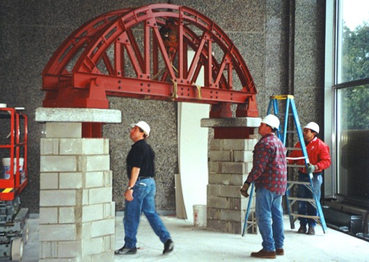 workers installing memorial in lobby